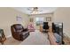Comfortable living room with lounge chair, a ceiling fan, and a desk area at 10409 Snowdon Flat Ct, Las Vegas, NV 89129