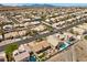 This high-angle shot shows the property's backyard, pool, landscaping, and surrounding neighborhood at 1043 Armillaria St, Henderson, NV 89011