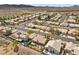 This elevated shot features desert landscaping, a pool, community surroundings and mountain views in the distance at 1043 Armillaria St, Henderson, NV 89011