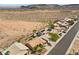 This elevated view displays a landscaped backyard, desert landscape, and mountain views from this lovely property at 1043 Armillaria St, Henderson, NV 89011