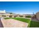 Backyard featuring artificial turf, desert landscaping, and mountain views at 1043 Armillaria St, Henderson, NV 89011