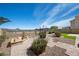 Desert landscaping with pavers, artificial turf, and mountain views at 1043 Armillaria St, Henderson, NV 89011