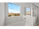 Bright bathroom features a soaking tub with a large window and glass enclosed shower at 1043 Armillaria St, Henderson, NV 89011