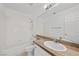 Bathroom featuring a granite-topped vanity and a tiled shower-tub combo at 1043 Armillaria St, Henderson, NV 89011