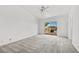 Spacious bedroom with carpeted floors, a ceiling fan, and sliding glass door leading to the outside at 1043 Armillaria St, Henderson, NV 89011