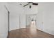 Bright bedroom featuring hardwood floors, a ceiling fan, and an open doorway at 1043 Armillaria St, Henderson, NV 89011