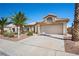 Inviting single-story home features a well-manicured lawn, desert landscaping, and a spacious two-car garage at 1043 Armillaria St, Henderson, NV 89011