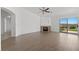 Bright living room with a cozy fireplace, wood-look floors, and sliding glass doors to backyard at 1043 Armillaria St, Henderson, NV 89011