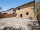 Spacious backyard with minimal landscaping, offering privacy with tall brick perimeter and adjacent homes nearby at 10609 Sand Mountain Ave, Las Vegas, NV 89166