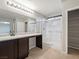Bathroom featuring double sinks, a walk-in shower, and tile flooring at 10609 Sand Mountain Ave, Las Vegas, NV 89166