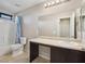 A bathroom features a vanity, shower/tub combo, and a large mirror at 10609 Sand Mountain Ave, Las Vegas, NV 89166