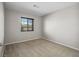 A bedroom features neutral carpet and a window with natural light at 10609 Sand Mountain Ave, Las Vegas, NV 89166
