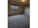 Bedroom featuring neutral walls and carpet, with natural light coming through a window at 10609 Sand Mountain Ave, Las Vegas, NV 89166