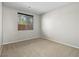 Bedroom featuring neutral carpet, paint, and a window that provides natural light at 10609 Sand Mountain Ave, Las Vegas, NV 89166