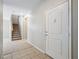 Bright entryway featuring tile flooring, stairs to the upper level, and a white front door at 10609 Sand Mountain Ave, Las Vegas, NV 89166