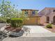 Two-story home with attached garage and desert landscaping for low maintenance at 10609 Sand Mountain Ave, Las Vegas, NV 89166