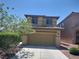 Two-story home featuring a two-car garage and a well-maintained front yard at 10609 Sand Mountain Ave, Las Vegas, NV 89166