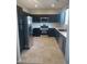 Kitchen featuring dark wood cabinets, stainless steel appliances, and tiled flooring at 10609 Sand Mountain Ave, Las Vegas, NV 89166