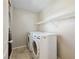 This laundry room features side-by-side washer and dryer and convenient shelving for storage at 10609 Sand Mountain Ave, Las Vegas, NV 89166