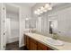 Well-lit bathroom with double sink vanity and tile counter at 11294 Corsica Mist Ave, Las Vegas, NV 89135