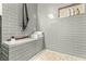 Bathroom features gray subway tiled shower, bench and toiletry niche at 11294 Corsica Mist Ave, Las Vegas, NV 89135