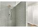 Sleek bathroom with gray subway tiles, rainfall shower head and wall mounted control system at 11294 Corsica Mist Ave, Las Vegas, NV 89135