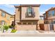 Inviting tan two-story home with a two-car garage and charming balcony on a sunny day at 11294 Corsica Mist Ave, Las Vegas, NV 89135