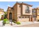 Beautiful two-story home featuring a stone facade, arched entryway, and two-car garage at 11294 Corsica Mist Ave, Las Vegas, NV 89135