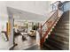 Open living area with tile floors, fireplace, staircase, and comfortable seating arrangement at 11294 Corsica Mist Ave, Las Vegas, NV 89135