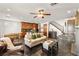 Spacious living room connects kitchen and stairs, featuring a fireplace and comfortable furnishings at 11294 Corsica Mist Ave, Las Vegas, NV 89135