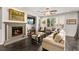 Cozy living room showcasing a fireplace, natural light, and comfortable furnishings for relaxation at 11294 Corsica Mist Ave, Las Vegas, NV 89135