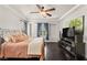 Comfortable main bedroom with a ceiling fan, tray ceiling and a window at 11294 Corsica Mist Ave, Las Vegas, NV 89135