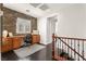 Home office space with built-in desk, cabinets, stone accent wall, and natural light at 11294 Corsica Mist Ave, Las Vegas, NV 89135