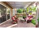 Inviting outdoor living space with covered patio, comfortable seating, and mature landscaping at 11294 Corsica Mist Ave, Las Vegas, NV 89135
