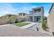 Two-story home featuring a backyard with artificial turf, gravel, and a covered patio at 12426 Oregon Cherry Ave, Las Vegas, NV 89138