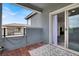 Balcony with faux wood flooring, gray walls, black metal railings and sliding glass door at 12426 Oregon Cherry Ave, Las Vegas, NV 89138
