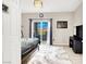 Bright bedroom with sliding glass doors to balcony, decorative rug and dark wood furniture at 12426 Oregon Cherry Ave, Las Vegas, NV 89138