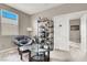 Bright bonus room with comfortable chair, glass table, display shelving, and lots of sunlight at 12426 Oregon Cherry Ave, Las Vegas, NV 89138