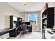 Home office featuring a dark wood desk and shelving near a bright window at 12426 Oregon Cherry Ave, Las Vegas, NV 89138
