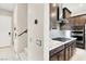 Well-equipped kitchen featuring stainless steel appliances, stylish dark cabinetry, and granite counters at 12426 Oregon Cherry Ave, Las Vegas, NV 89138