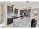 A modern kitchen with granite countertops, stainless steel appliances, and a stylish backsplash at 12426 Oregon Cherry Ave, Las Vegas, NV 89138