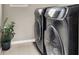 Laundry room with modern washer and dryer, tiled floor, and a house plant at 12426 Oregon Cherry Ave, Las Vegas, NV 89138