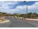 Street view of a new community with lush landscaping, sidewalk and the Bristle Vale sign in the background at 12426 Oregon Cherry Ave, Las Vegas, NV 89138