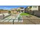 Landscaped backyard featuring an outdoor seating area and a modern fire pit at 12532 Blissful Sky St, Las Vegas, NV 89138