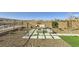 Inviting backyard area featuring a stone fire pit, cozy seating, and stunning mountain views at 12532 Blissful Sky St, Las Vegas, NV 89138