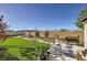 Well-manicured backyard with artificial turf, desert landscaping, and views at 12532 Blissful Sky St, Las Vegas, NV 89138
