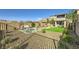Spacious backyard with a fire pit, patio, and artificial grass perfect for outdoor relaxation and entertaining at 12532 Blissful Sky St, Las Vegas, NV 89138