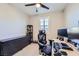 Bright bedroom featuring a ceiling fan, window with shutters, and space for a home office setup at 12532 Blissful Sky St, Las Vegas, NV 89138