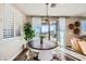 Bright dining area features a rustic wood table, modern light fixture, and sliding doors to the outdoor patio at 12532 Blissful Sky St, Las Vegas, NV 89138