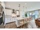 Modern kitchen with white cabinets, stainless steel appliances, a large island, and pendant lighting at 12532 Blissful Sky St, Las Vegas, NV 89138